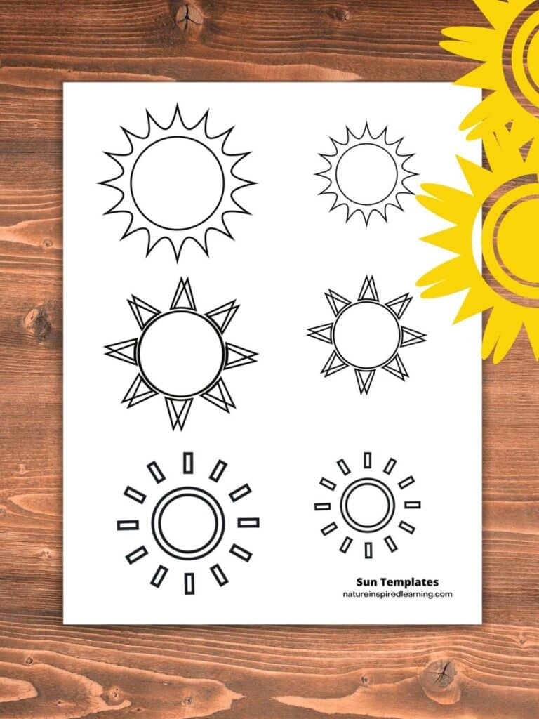 Sun coloring page with three different sun designs. Medium and small suns on the page. Wooden background with two bright yellow suns in the upper right corner.