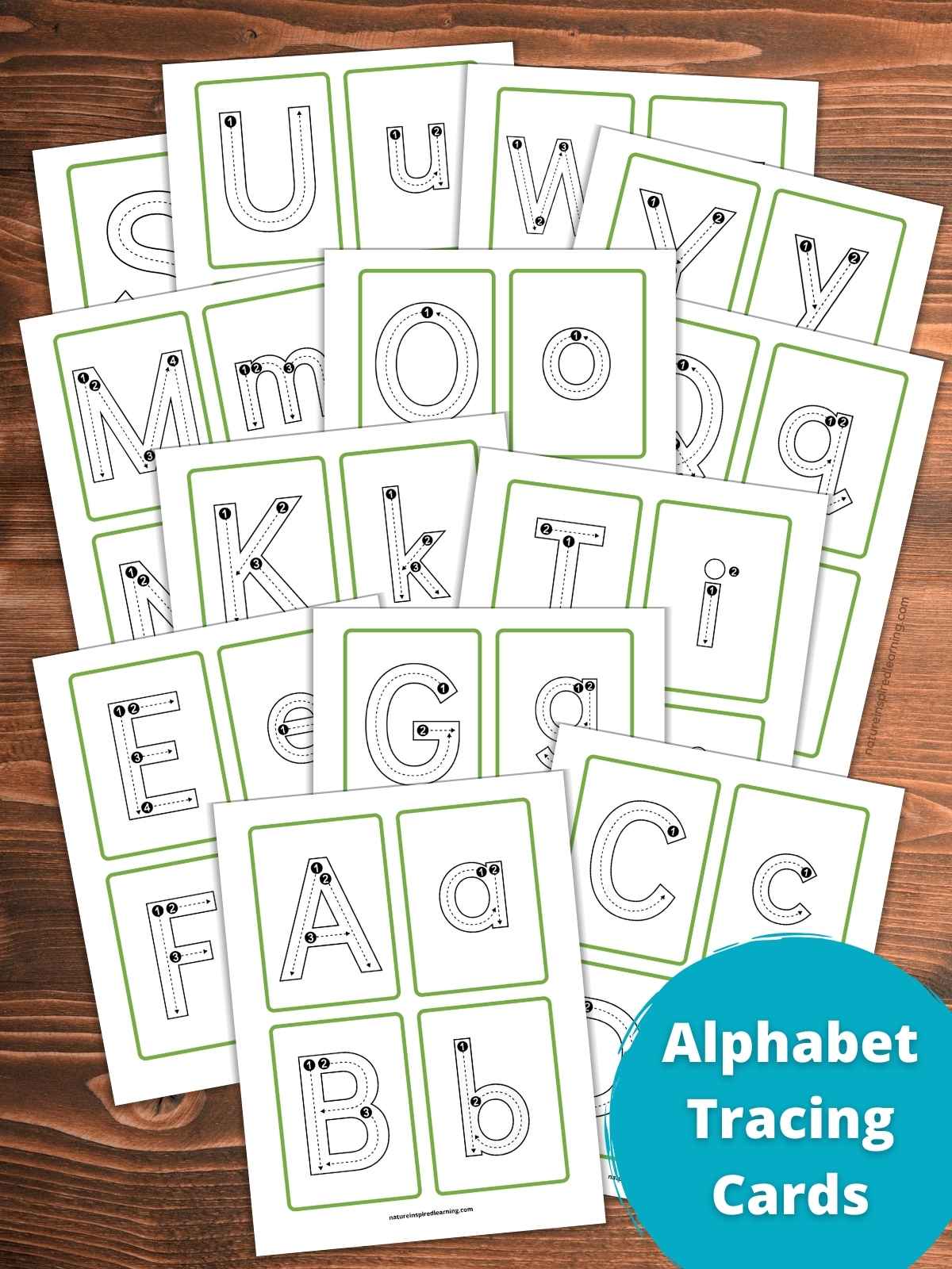 full set of uppercase and lowercase letter tracing cards with letters a through z. Each letter has dashed guidelines and numbers within the outline of the letter. Cards have a white background with a simple green outline. Set of printables overlapping on a wooden background with a blue circle bottom right with text overlay.