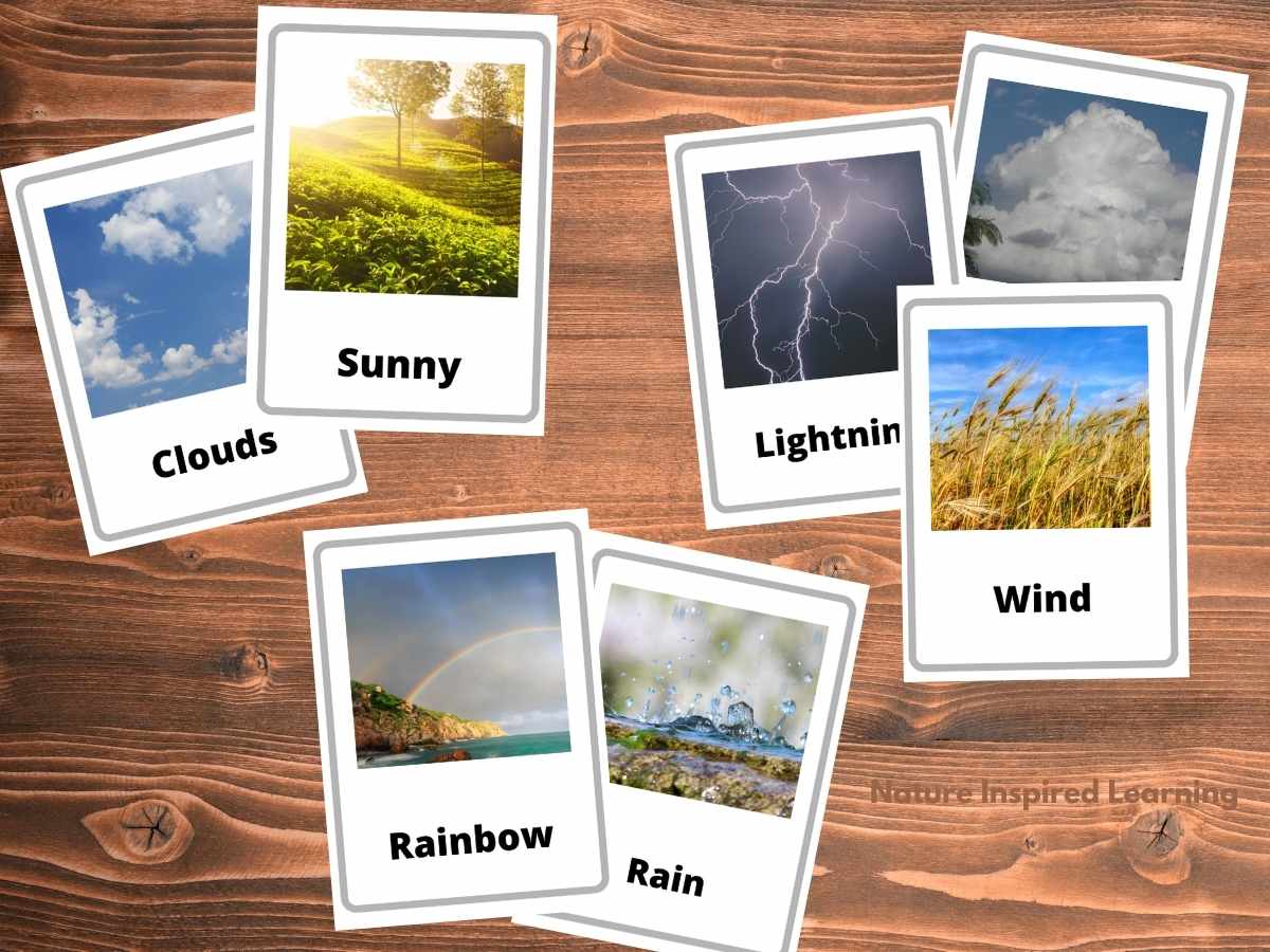 cut out weather flashcards grouped by similar characteristics: clouds and sun, then lightning storm cloud, and wind, then rainbow and rain cards. Printable cards placed in three groups on a wooden background