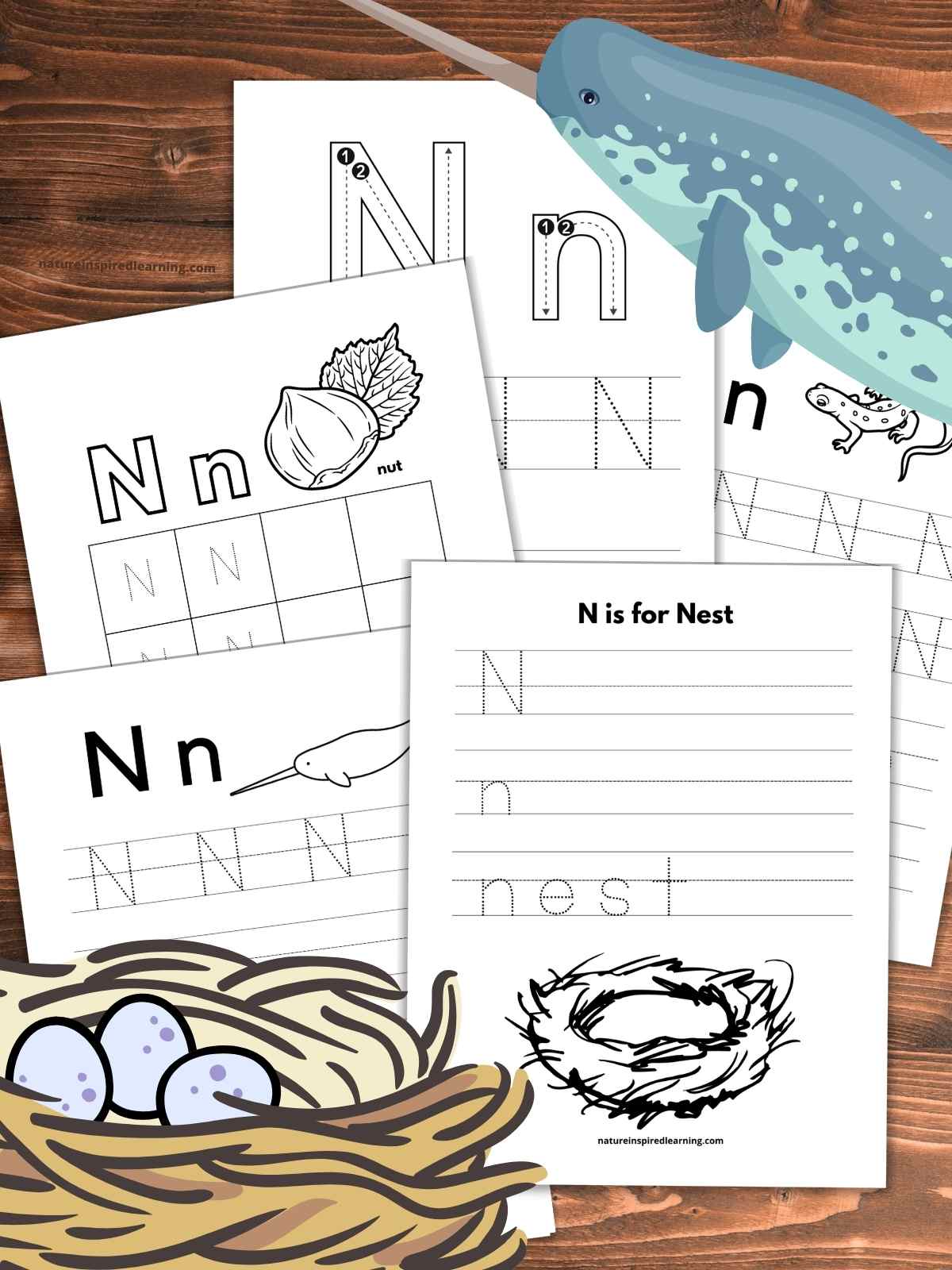 five letter tracing worksheets overlapping on a wooden background with a narwhal upper right corner and nest with three blue eggs bottom left