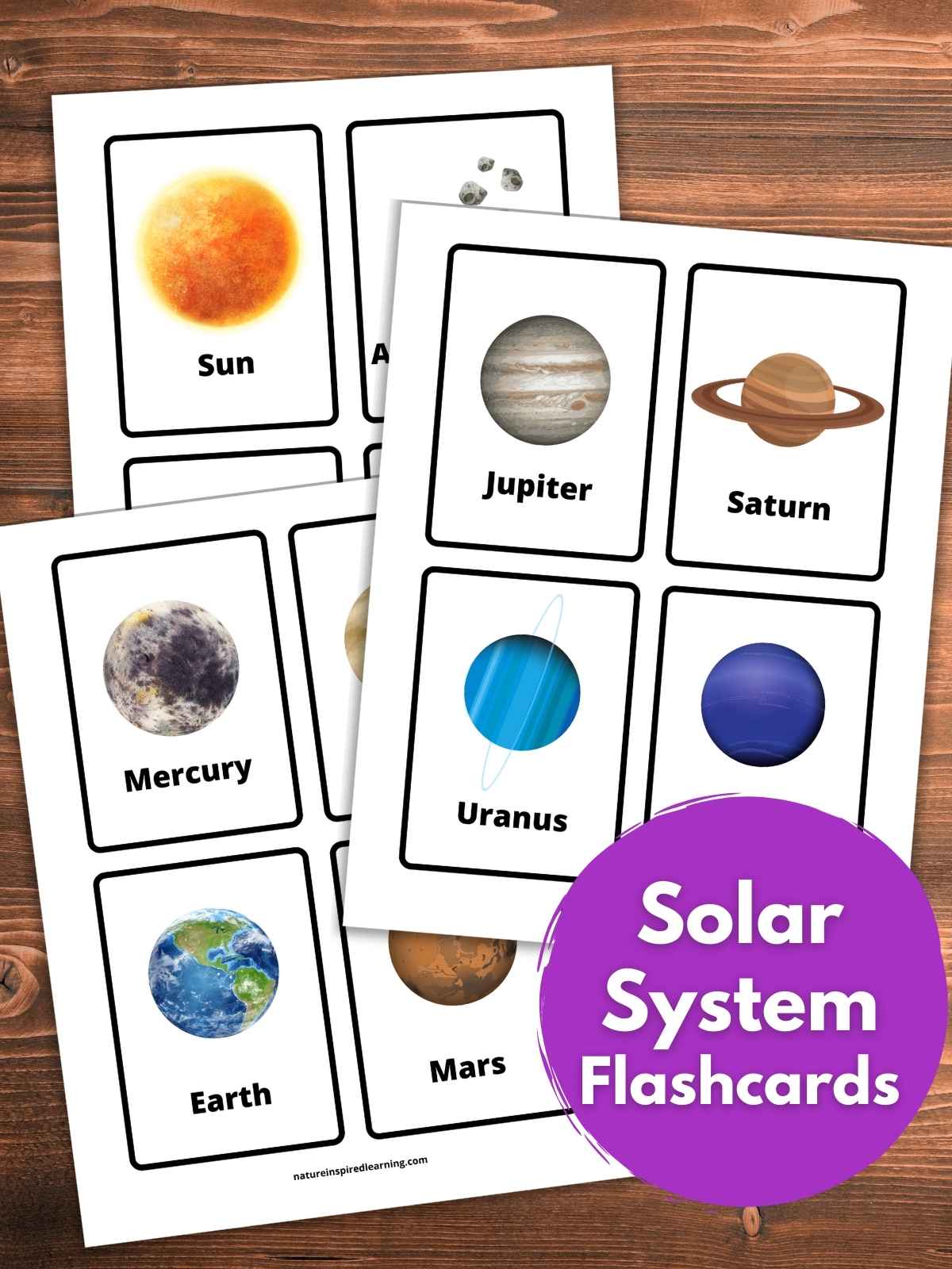 Four printed out sheets with flashcards with planets and objects in our solar system. Colorful realistic image of each planet and object with a label below in black text. Printables on a wooden background with purple circle bottom right with text overlay.