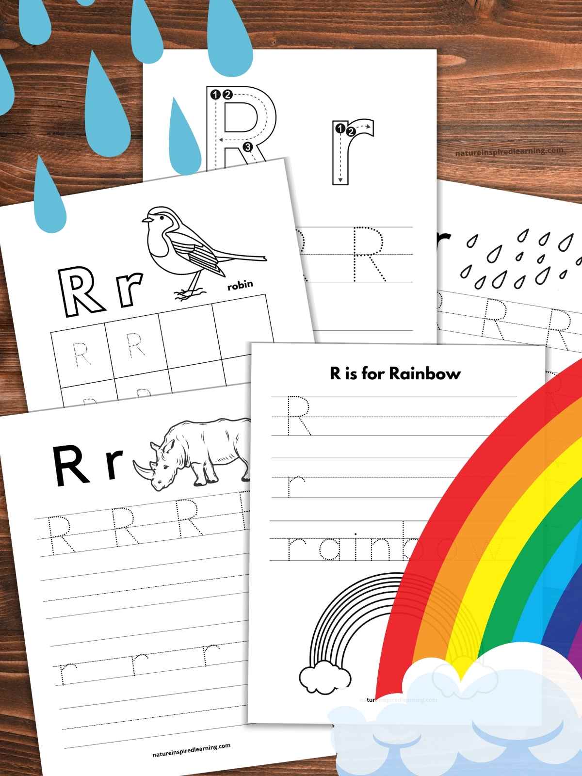 Five letter R tracing worksheets overlapping on a wooden background with blue raindrops upper left rainbow with cloud bottom right