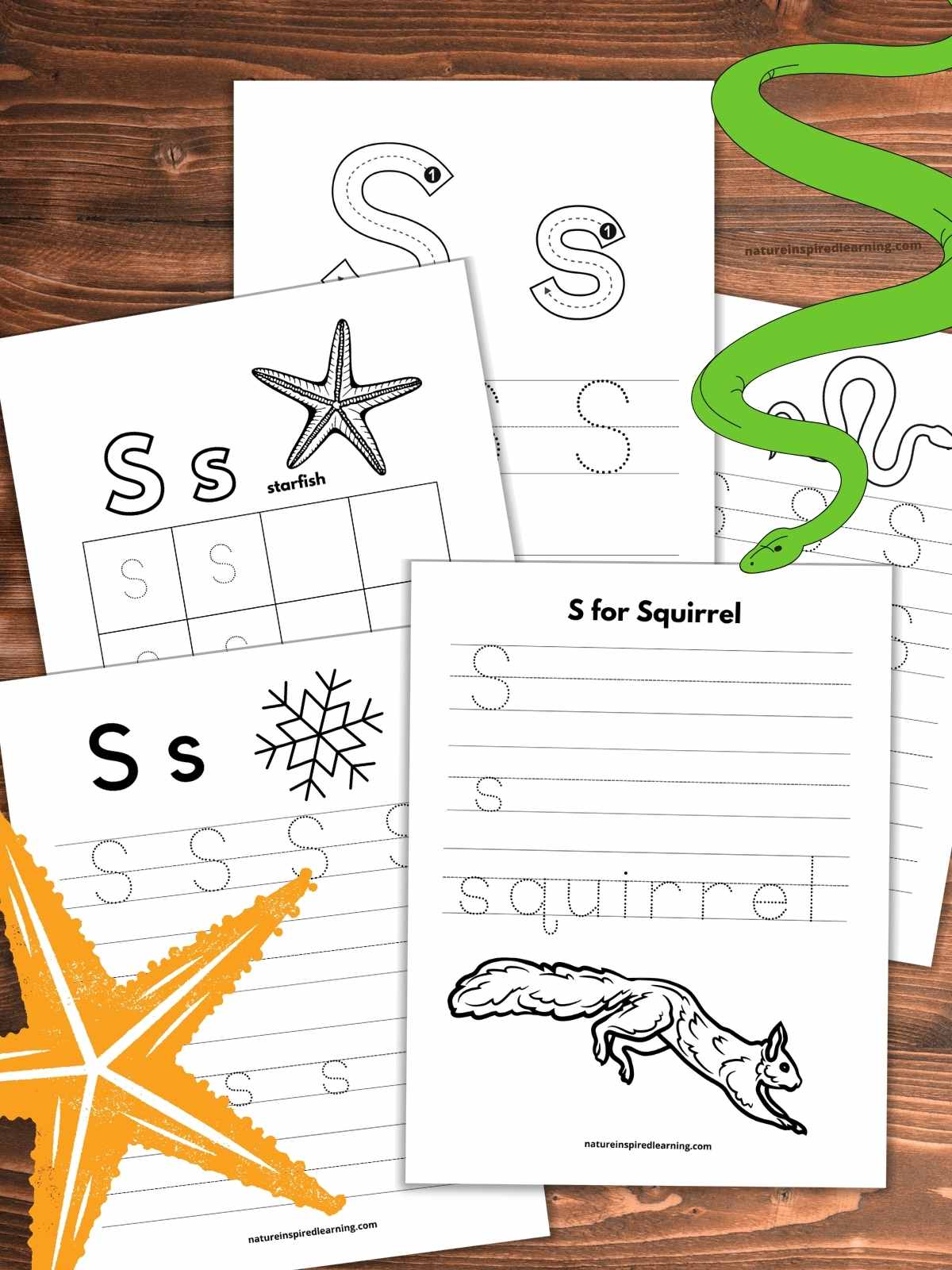 five letter tracing worksheets overlapping on a wooden background with yellow starfish bottom left green snake upper right