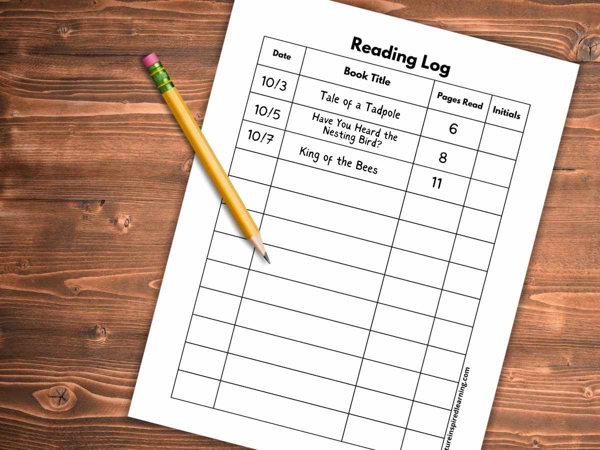 printable reading log with rows and columns for book titles, dates, pages, and initials partially filled out with a pencil on top all on a wooden background