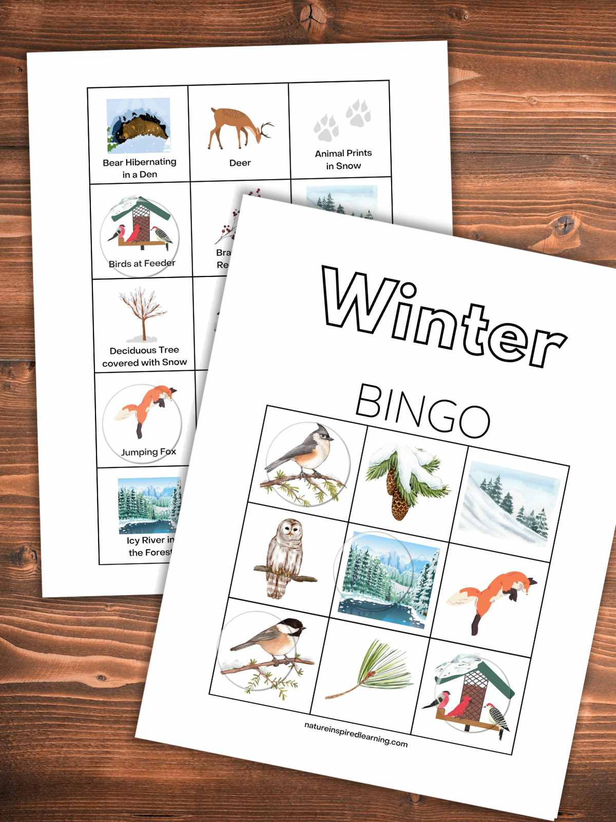 Printable bingo card with winter designs on top of the calling cards on a wooden background