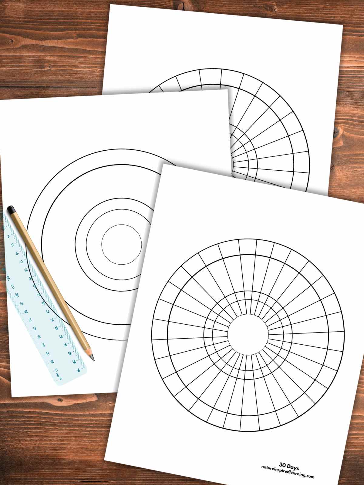 three overlapping calendars in circle form two with lines one without lines with a clear ruler and a pencil on top with a wooden background.