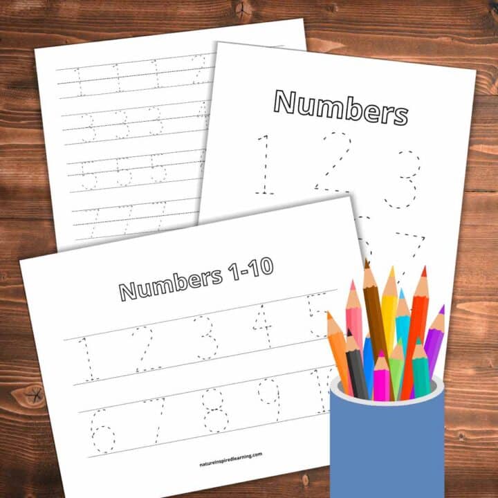 number tracing worksheets for numbers 1-10 overlapping each other on a wooden background with colored pencils in a cup bottom right.