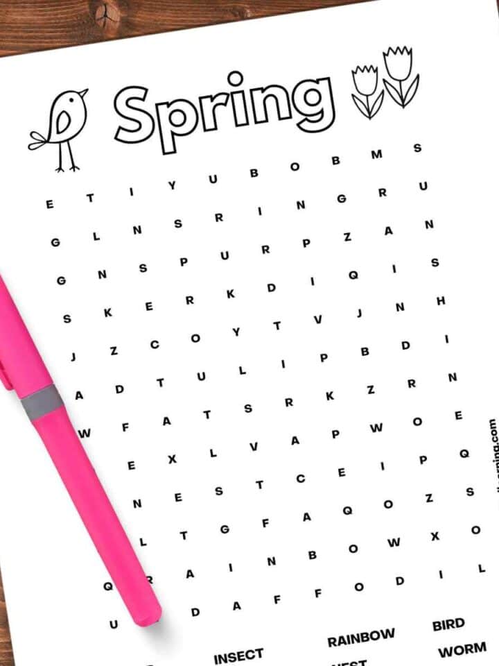 black and white printable word search with spring terms with a bright pink highlighter on top of the left side with a drop shadow on a wooden background.