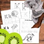 Five black and white tracing worksheets for the letter k overlapping on a wooden background. Two green kiwi's cut open on the bottom left and a koala on a branch in the upper right.